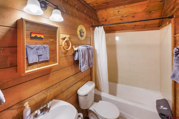 a backyard of a house with a yard table and chairs