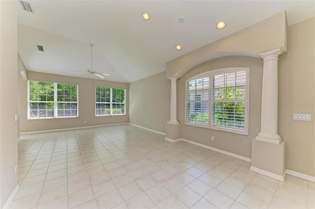 an empty room with a empty space and windows