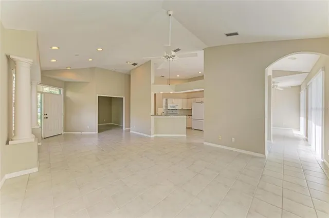 a kitchen with granite countertop white cabinets and white appliances