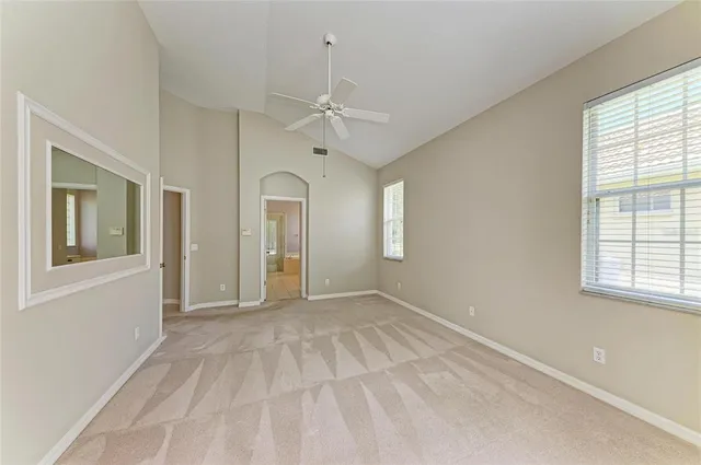 a bedroom with a large bed and a large window