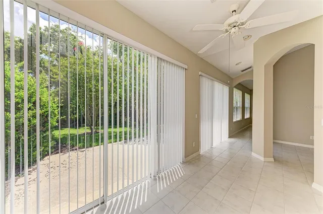 a view of a sign in a yard with palm trees