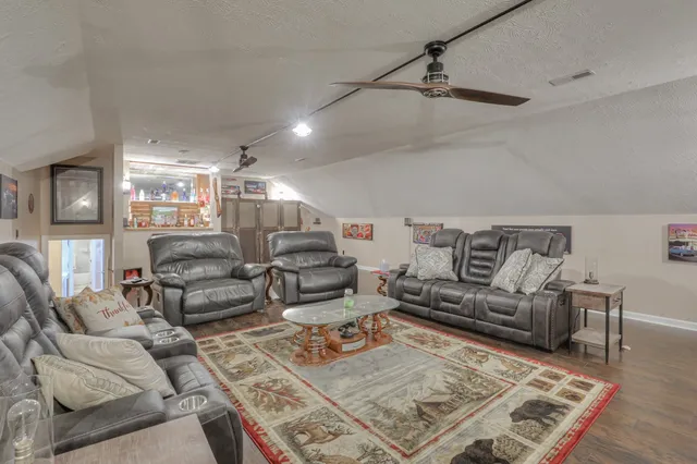 a house view with a play ground and a large tree