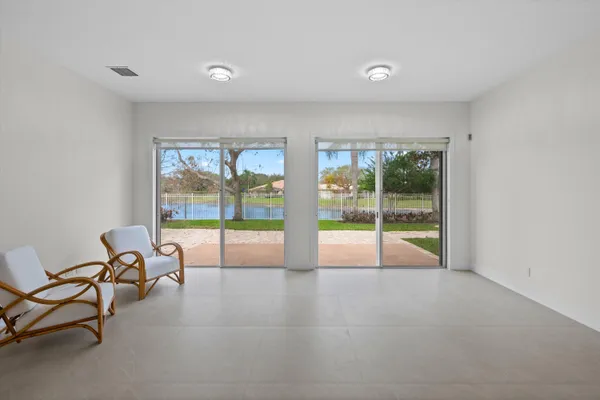 a view of an empty room with glass door