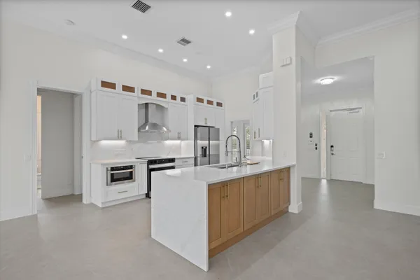 a kitchen with stainless steel appliances kitchen island a sink stove and cabinets