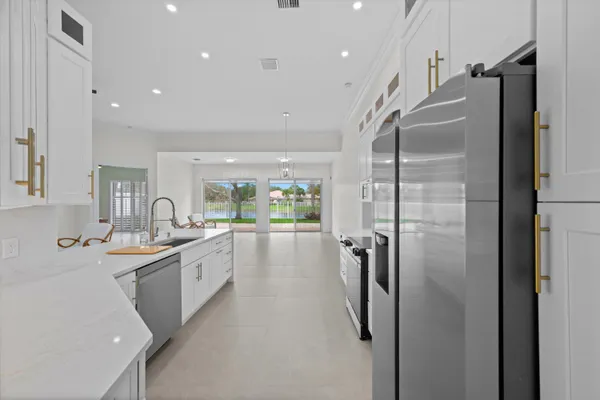 a kitchen with kitchen island a sink appliances and cabinets