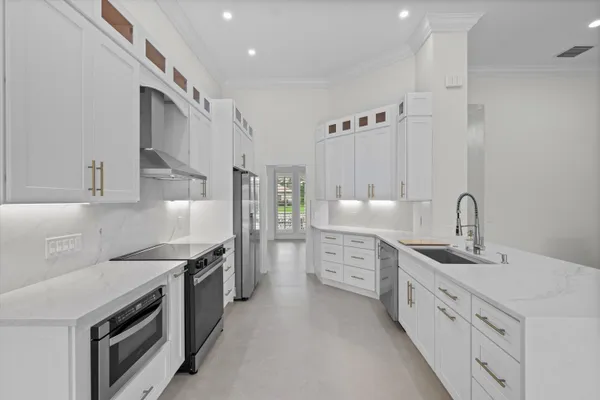 a kitchen with granite countertop a sink stove and cabinets
