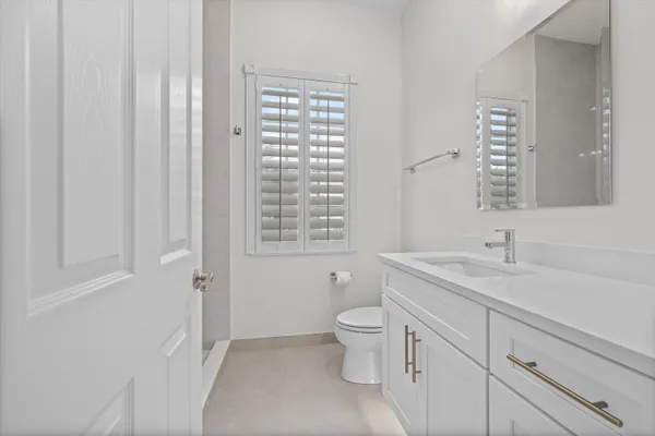 a bathroom with a glass shower door