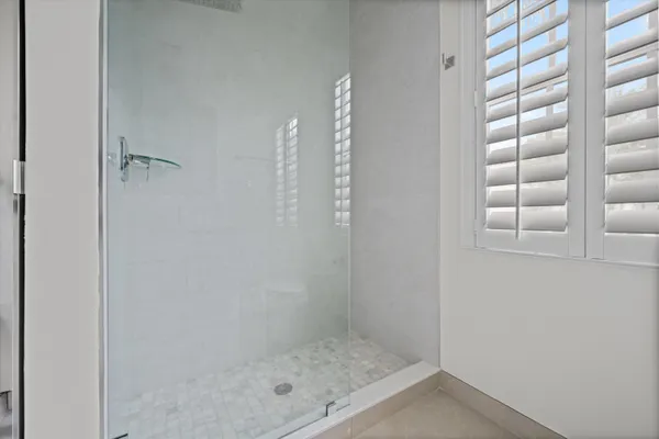 an empty room with ceiling fan and window