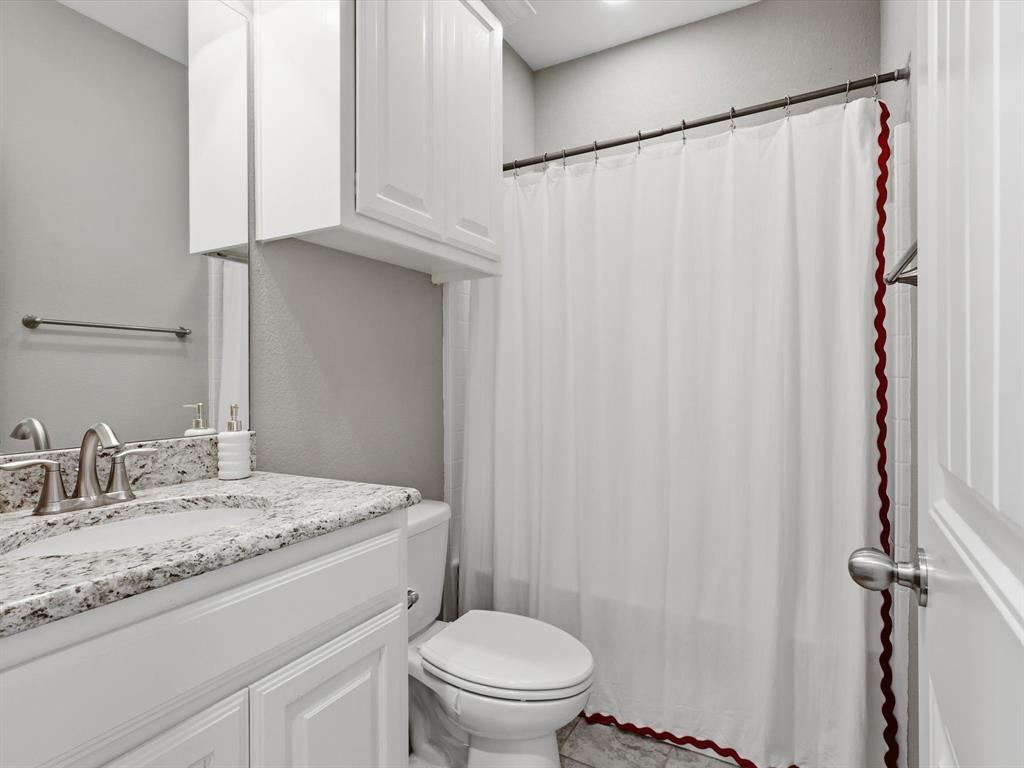 810 Chestnut Grove Drive Cleburne, TX 76033 - Photo 12 of 40 a bathroom with a granite countertop sink toilet and a mirror