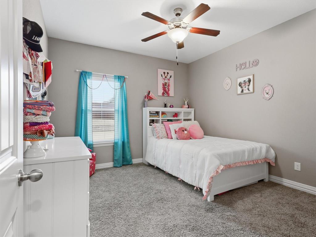 810 Chestnut Grove Drive Cleburne, TX 76033 - Photo 13 of 40 a bedroom with a bed and a chandelier