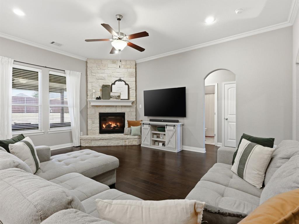 810 Chestnut Grove Drive Cleburne, TX 76033 - Photo 18 of 40 a living room with furniture flat screen tv and a fireplace