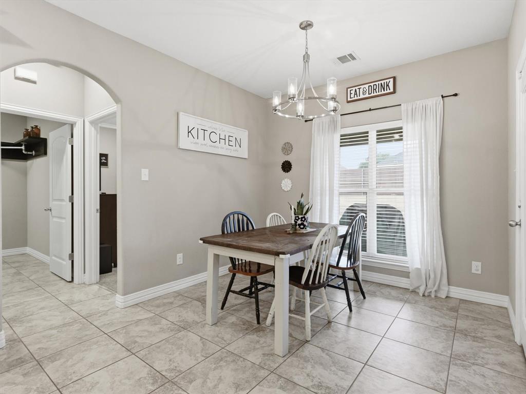 810 Chestnut Grove Drive Cleburne, TX 76033 - Photo 26 of 40 a view of a dining room with furniture and a chandelier