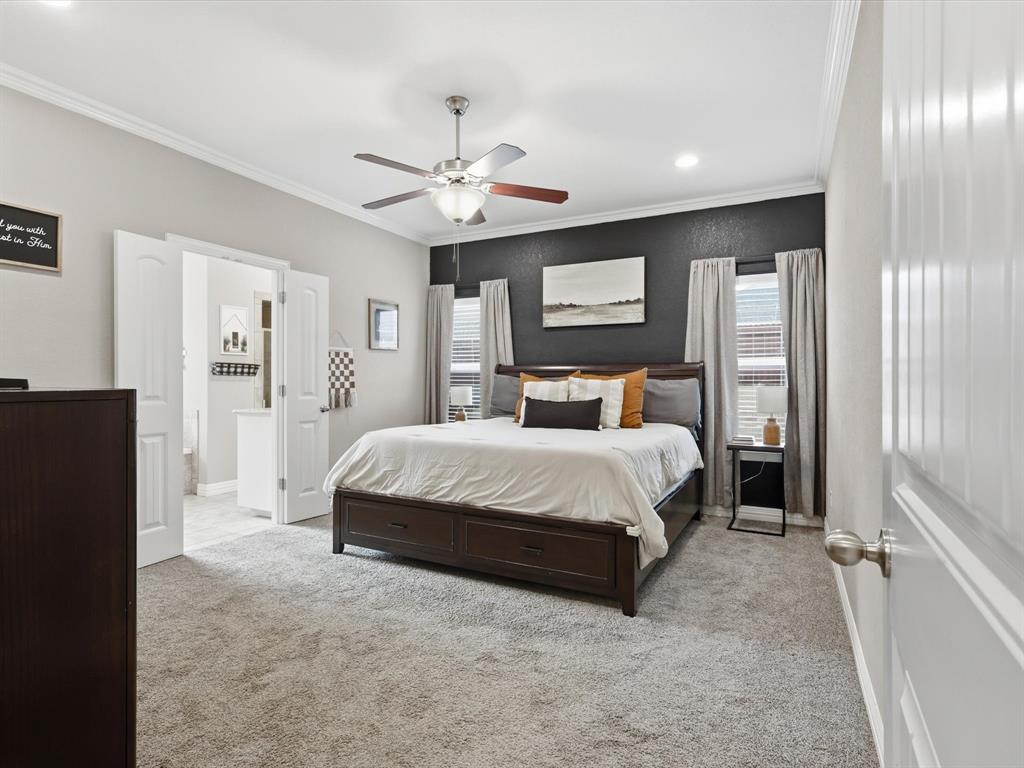 810 Chestnut Grove Drive Cleburne, TX 76033 - Photo 30 of 40 a bedroom with a large bed and a chandelier