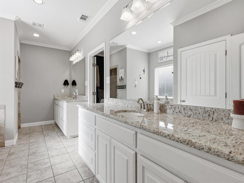 810 Chestnut Grove Drive Cleburne, TX 76033 - Photo 36 of 40 a spacious bathroom with a granite countertop sink mirror and vanity