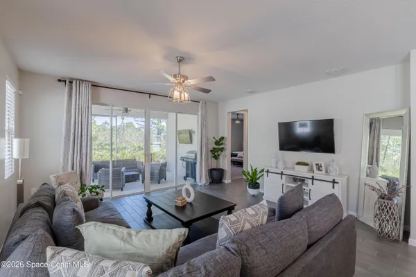 a living room with furniture and a flat screen tv