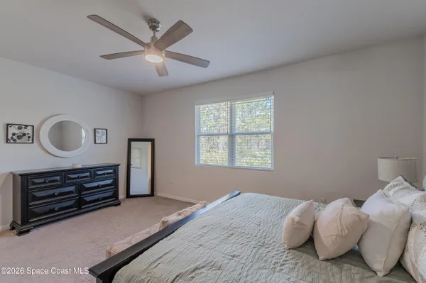 a bedroom with bed and a window