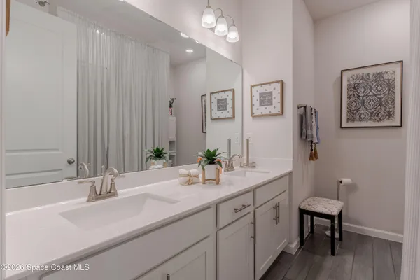 a bathroom with a double vanity sink and a mirror