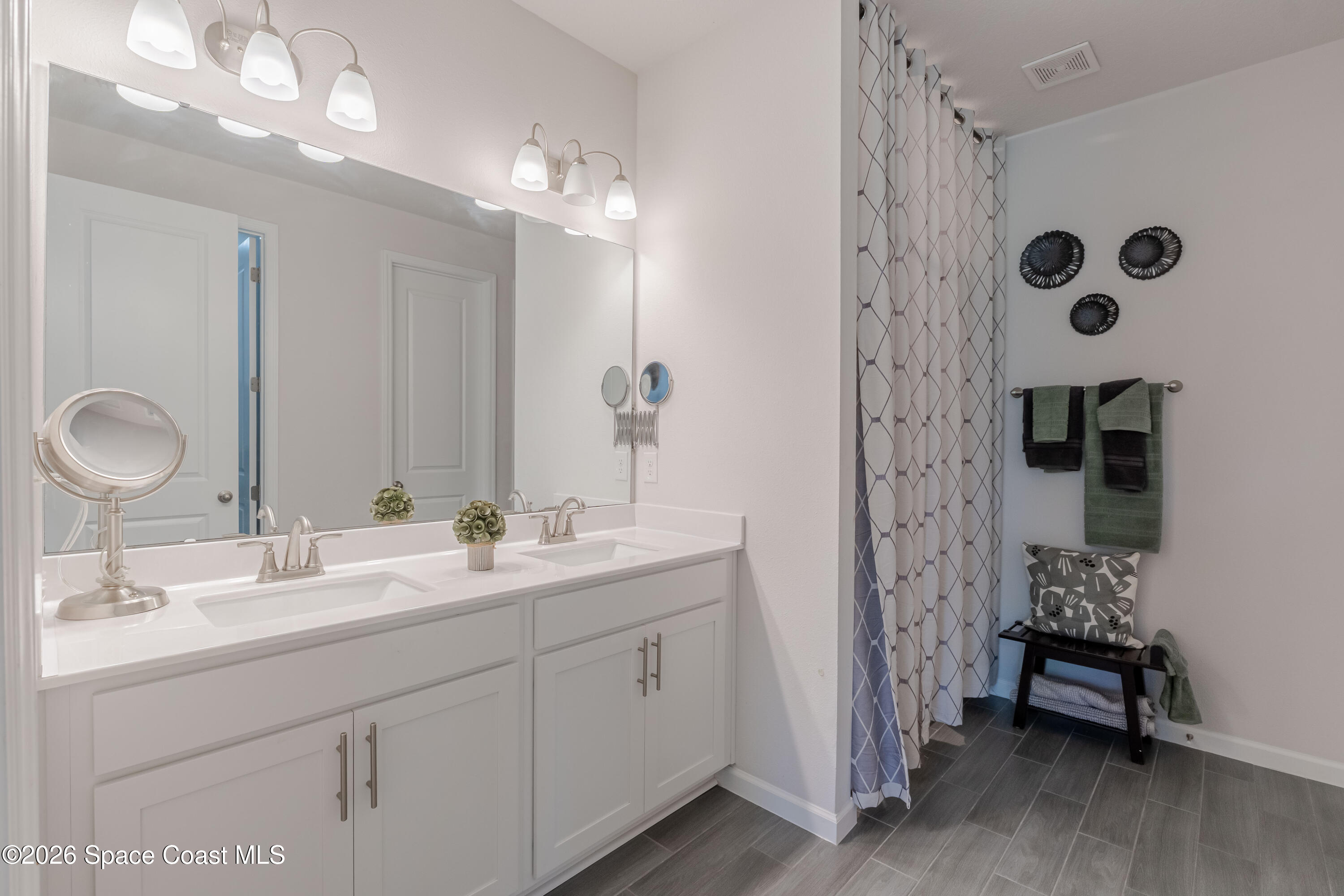 4342 Southern Vista Loop St. Cloud, FL 34772 - Photo 19 of 30 a spacious bathroom with double vanity and a mirror