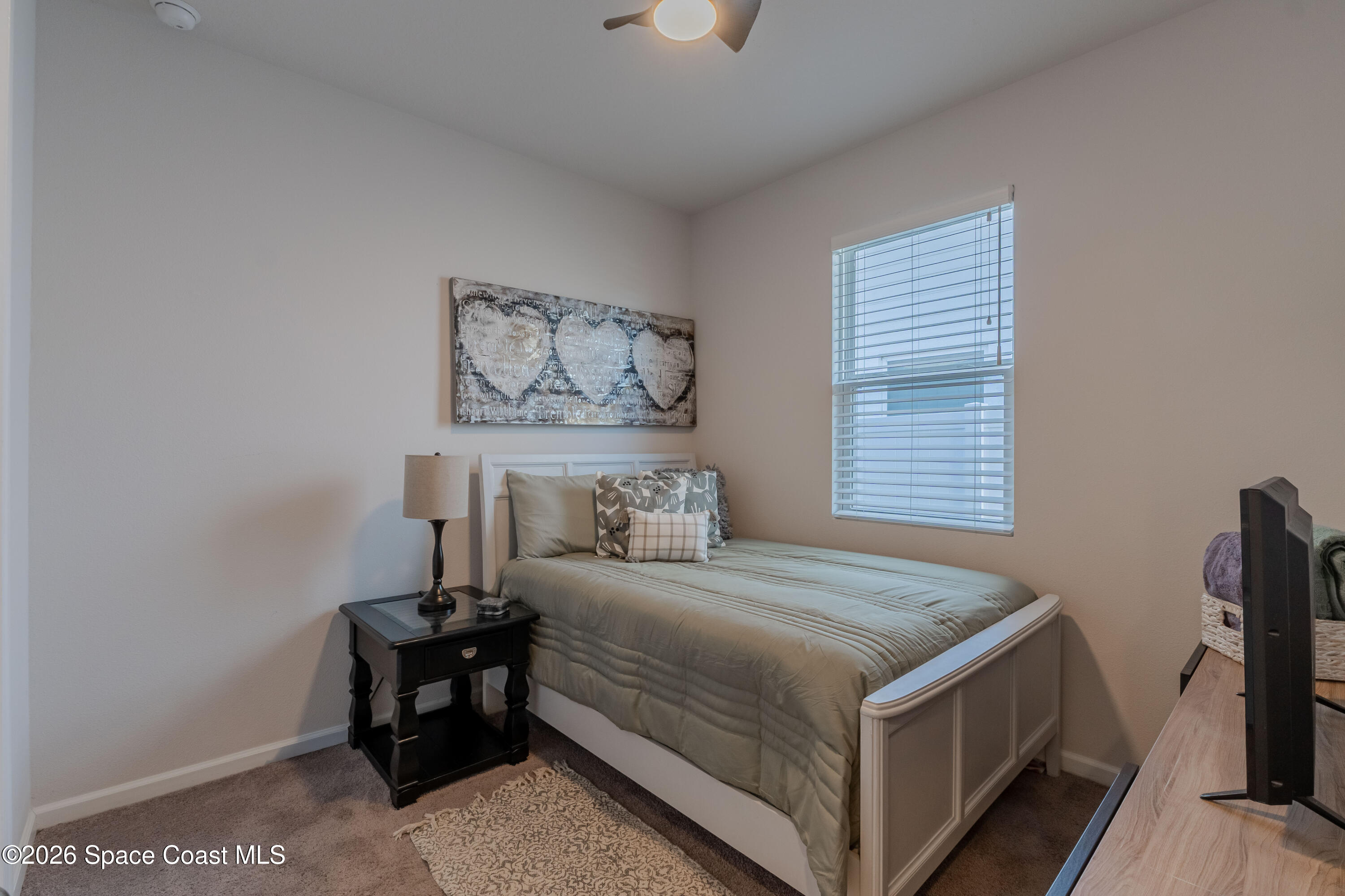 4342 Southern Vista Loop St. Cloud, FL 34772 - Photo 20 of 30 a bedroom with a bed and a table in it