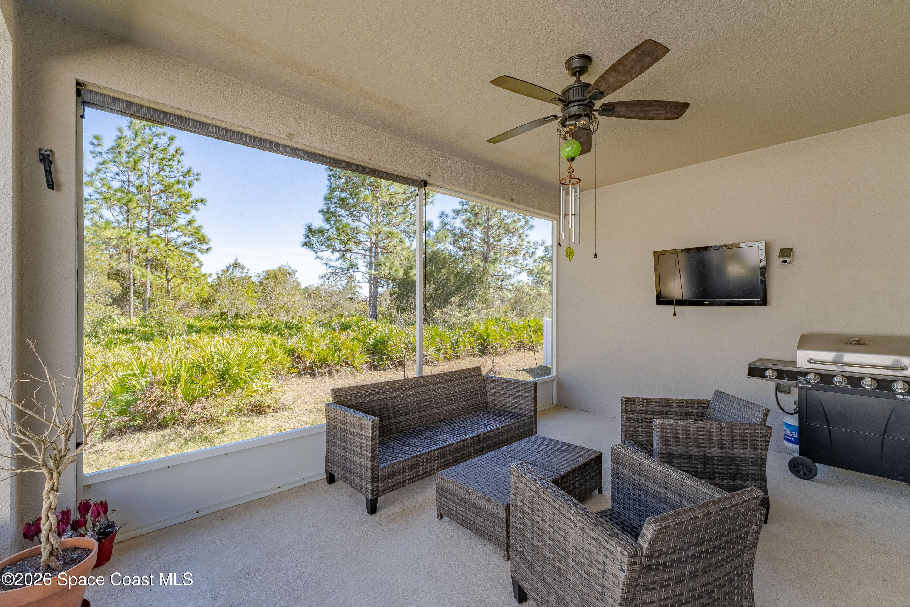 4342 Southern Vista Loop St. Cloud, FL 34772 - Photo 23 of 30 a living room with furniture tv and a large window