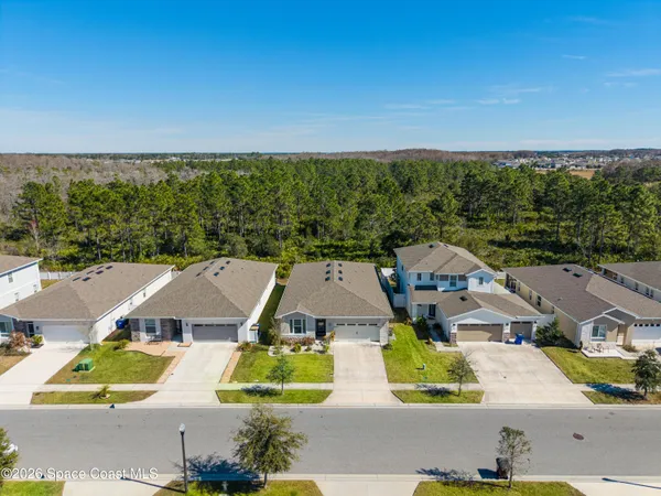 an aerial view of residential houses with outdoor space and street view