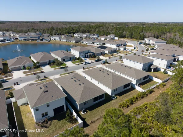 an aerial view of a house with a lake view
