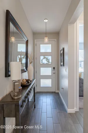 a view of kitchen with windows and refrigerator