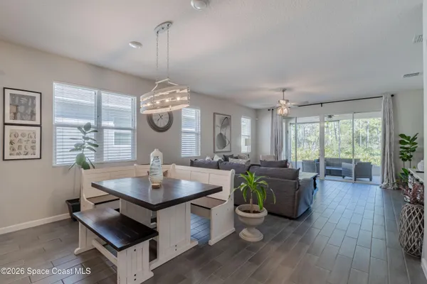 a living room with furniture a window and dining table
