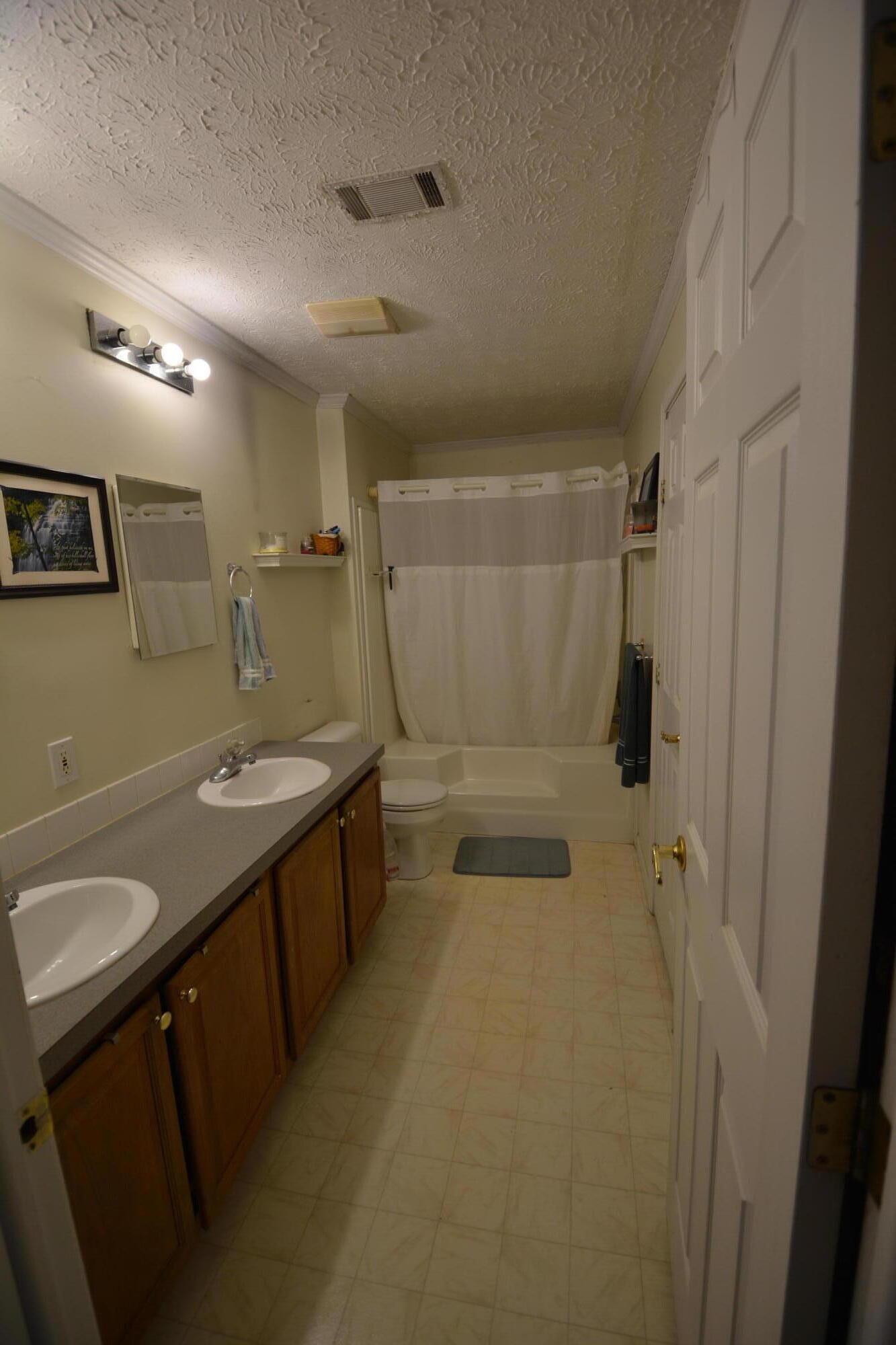 6880 Fork Mountain Road Rocky Mount, VA 24151 - Photo 11 of 22 a bathroom with a sink toilet and shower