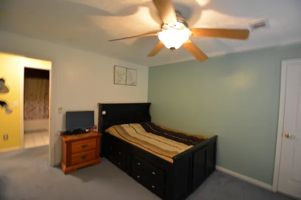 a bedroom with a bed and a chandelier