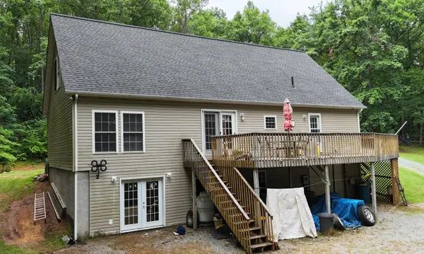 a roof deck with wooden floor and fence