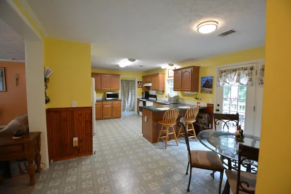 a view of a dining room with furniture and window