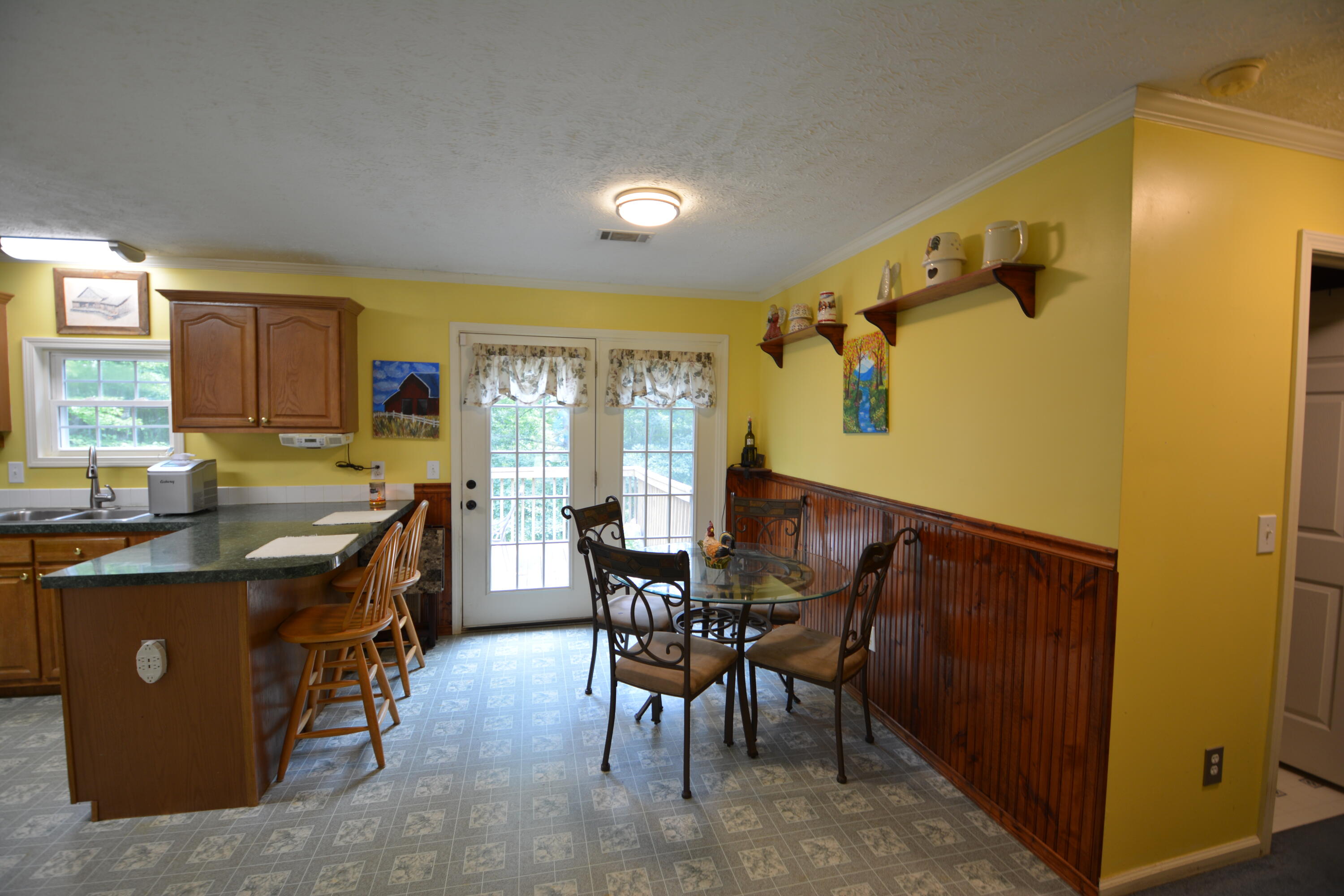 6880 Fork Mountain Road Rocky Mount, VA 24151 - Photo 4 of 22 a kitchen with stainless steel appliances granite countertop sink stove and wooden cabinets