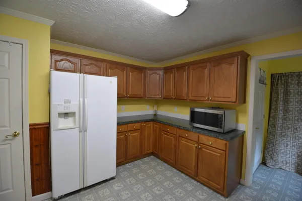 a kitchen with a refrigerator sink and microwave