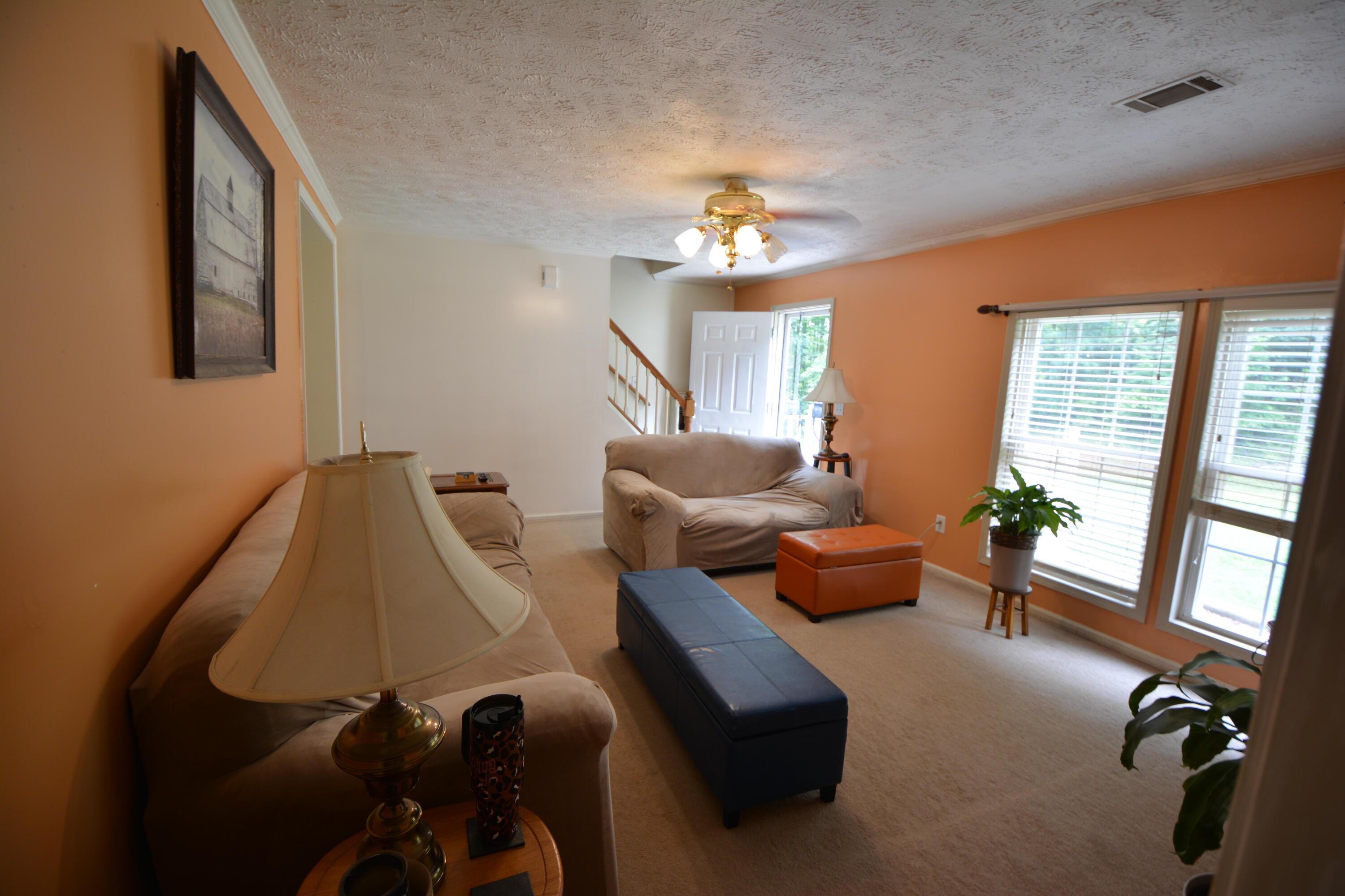6880 Fork Mountain Road Rocky Mount, VA 24151 - Photo 9 of 22 a living room with furniture chandelier and a large window