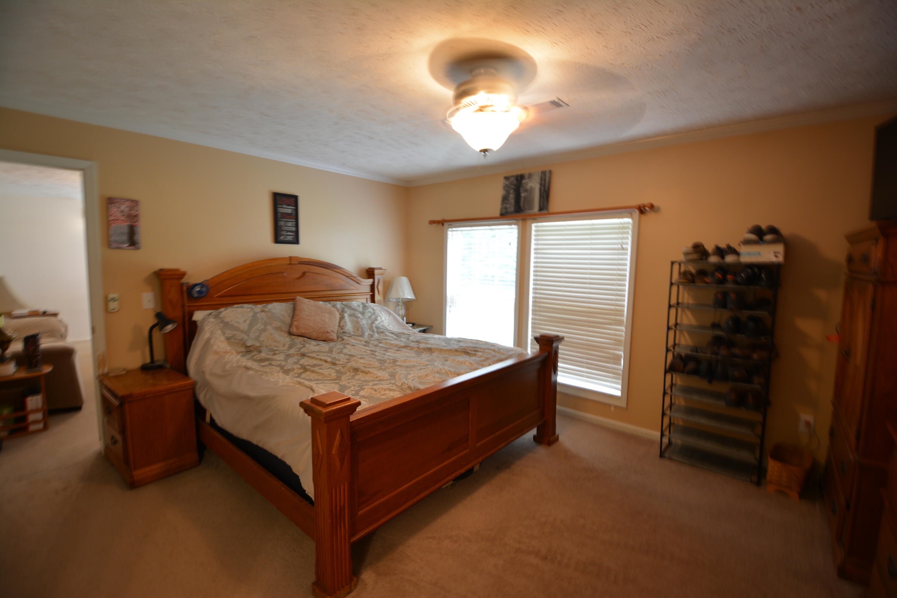 6880 Fork Mountain Road Rocky Mount, VA 24151 - Photo 10 of 22 a bedroom with a bed and a chandelier