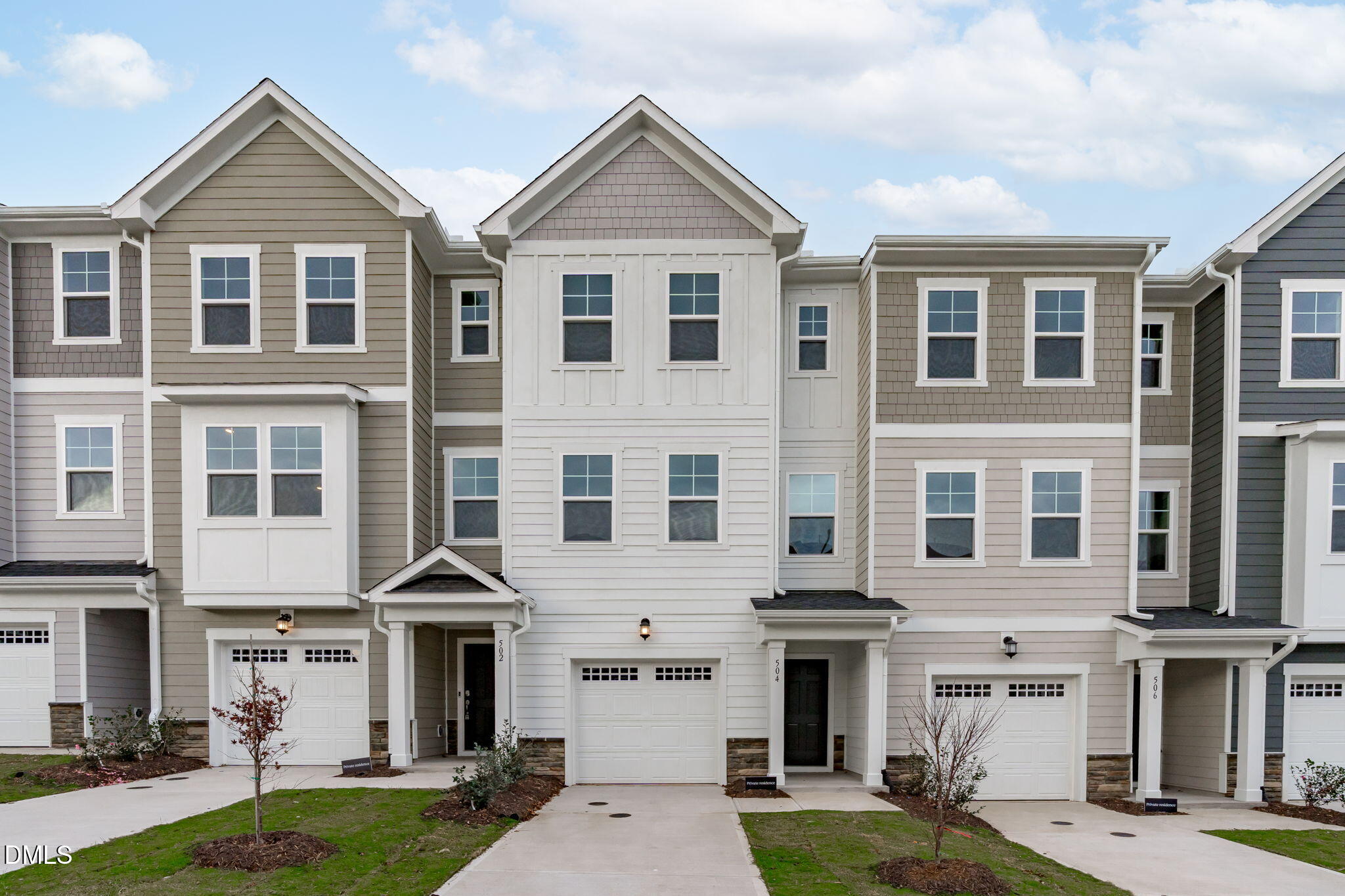 a front view of a residential apartment building with yard