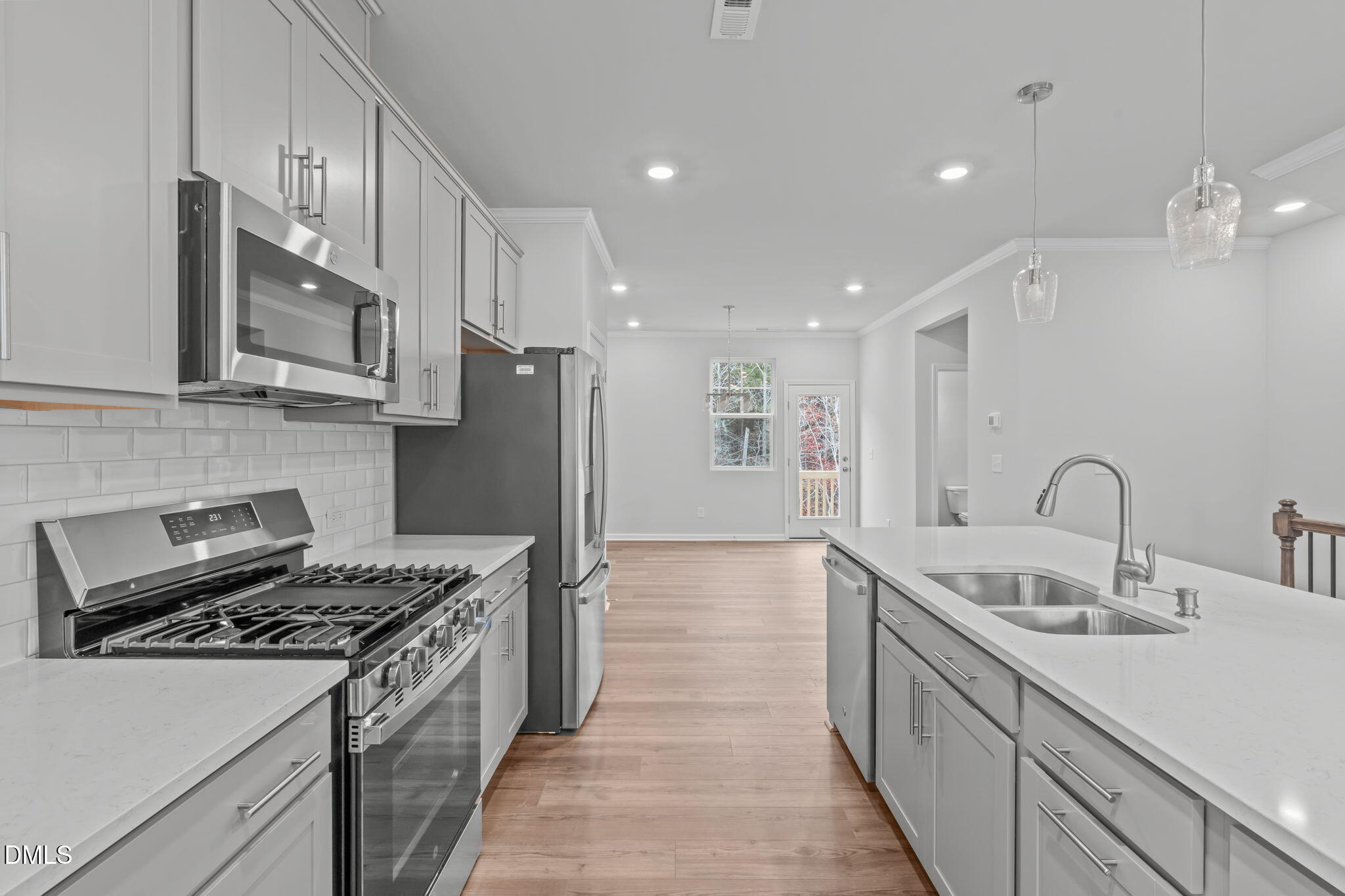 504 Light Oak Way Apex, NC 27539 - Photo 12 of 38 a kitchen with a sink stove and refrigerator