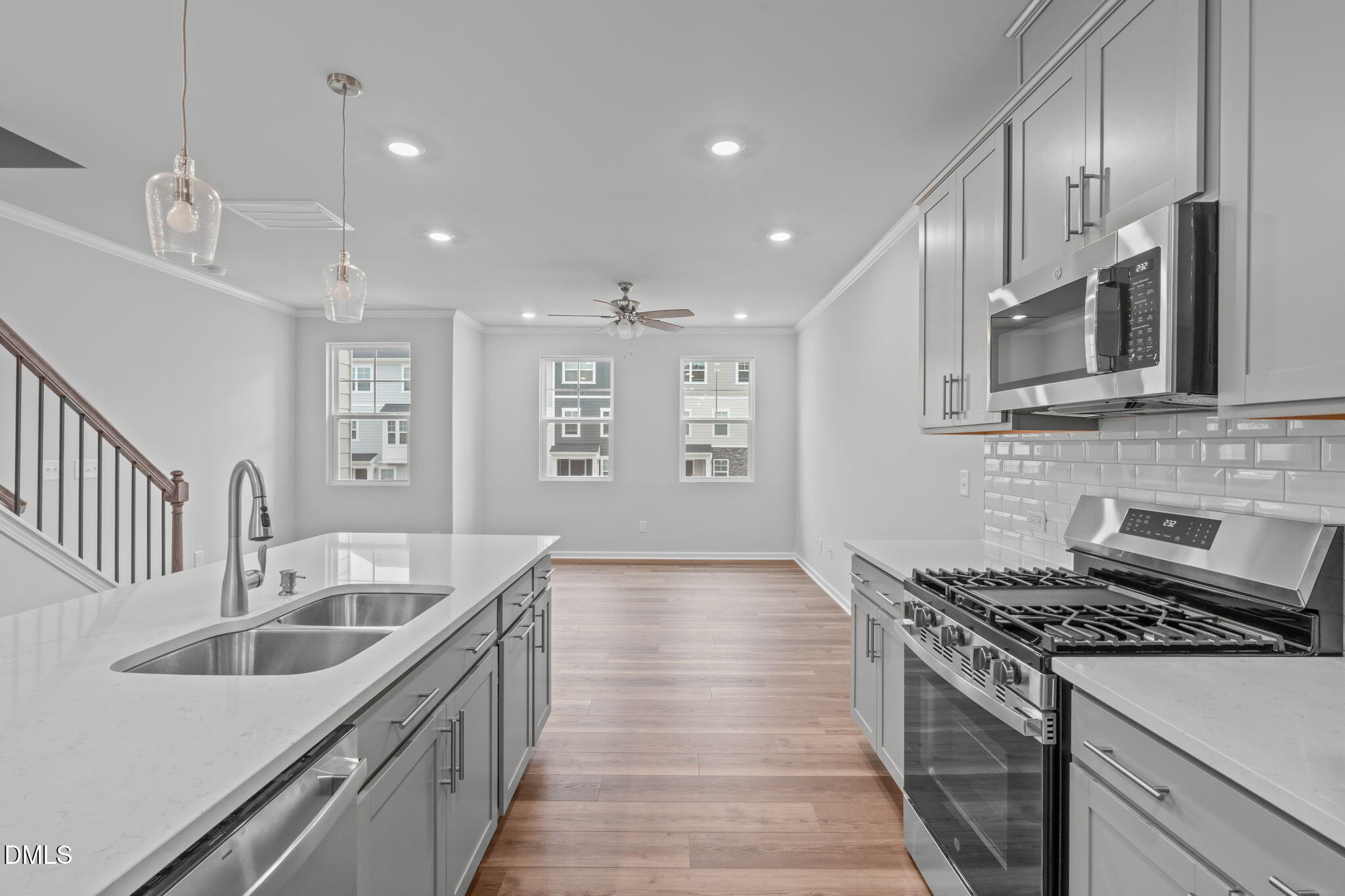 504 Light Oak Way Apex, NC 27539 - Photo 14 of 38 a kitchen with granite countertop a sink stove and cabinets