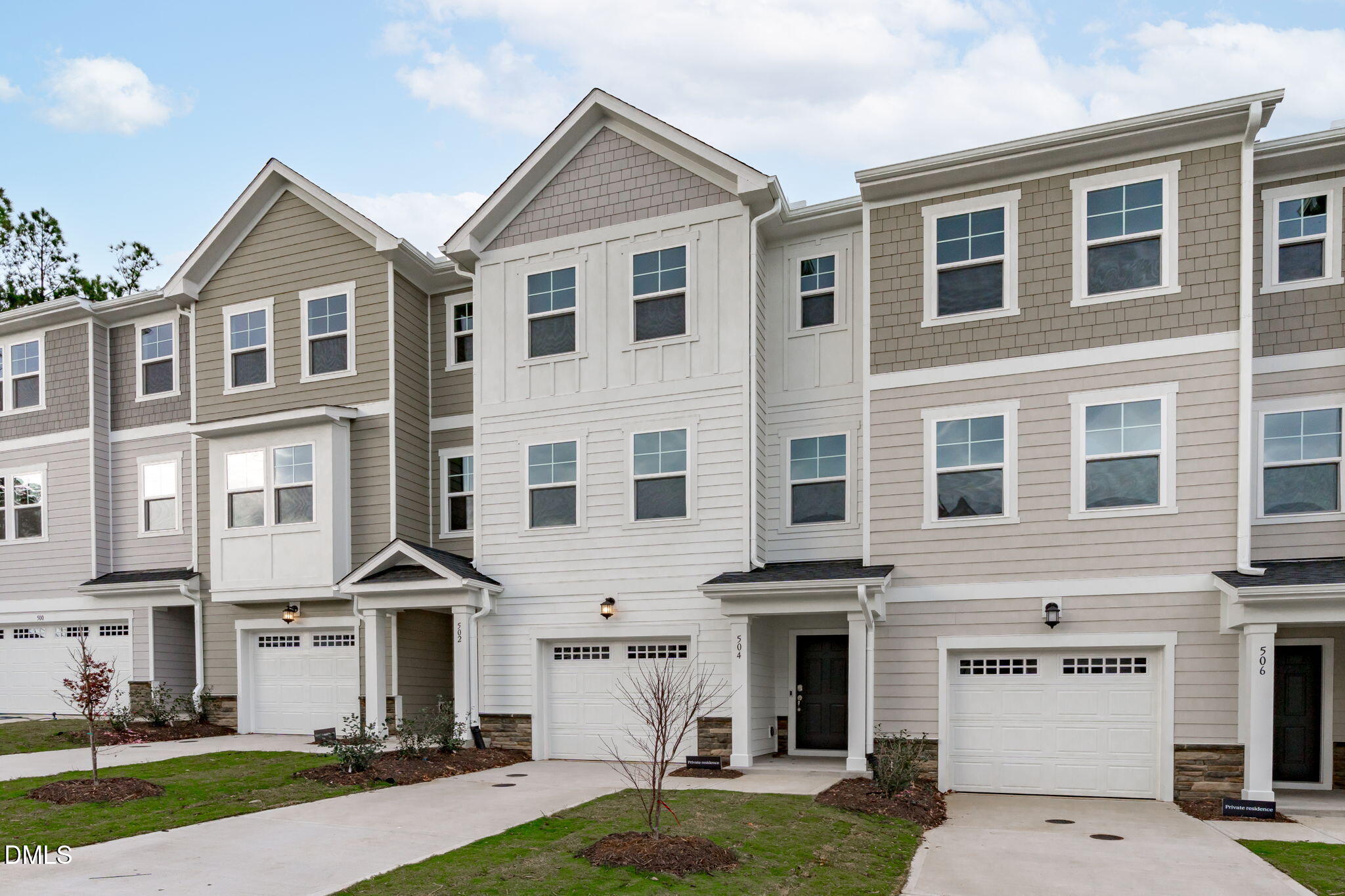 504 Light Oak Way Apex, NC 27539 - Photo 2 of 38 a front view of a house with a yard and garage
