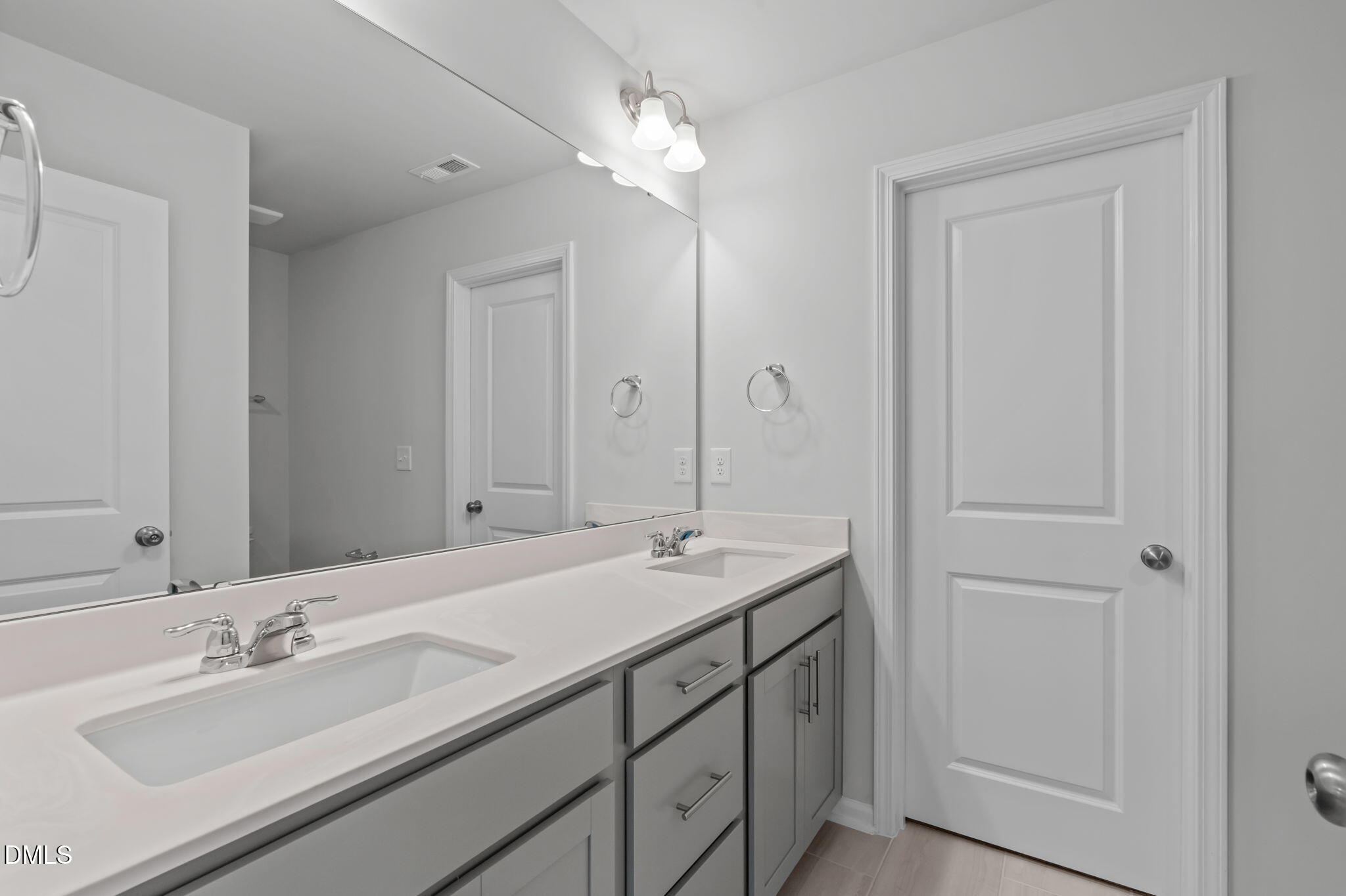 504 Light Oak Way Apex, NC 27539 - Photo 30 of 38 a bathroom with a sink double vanity and a mirror