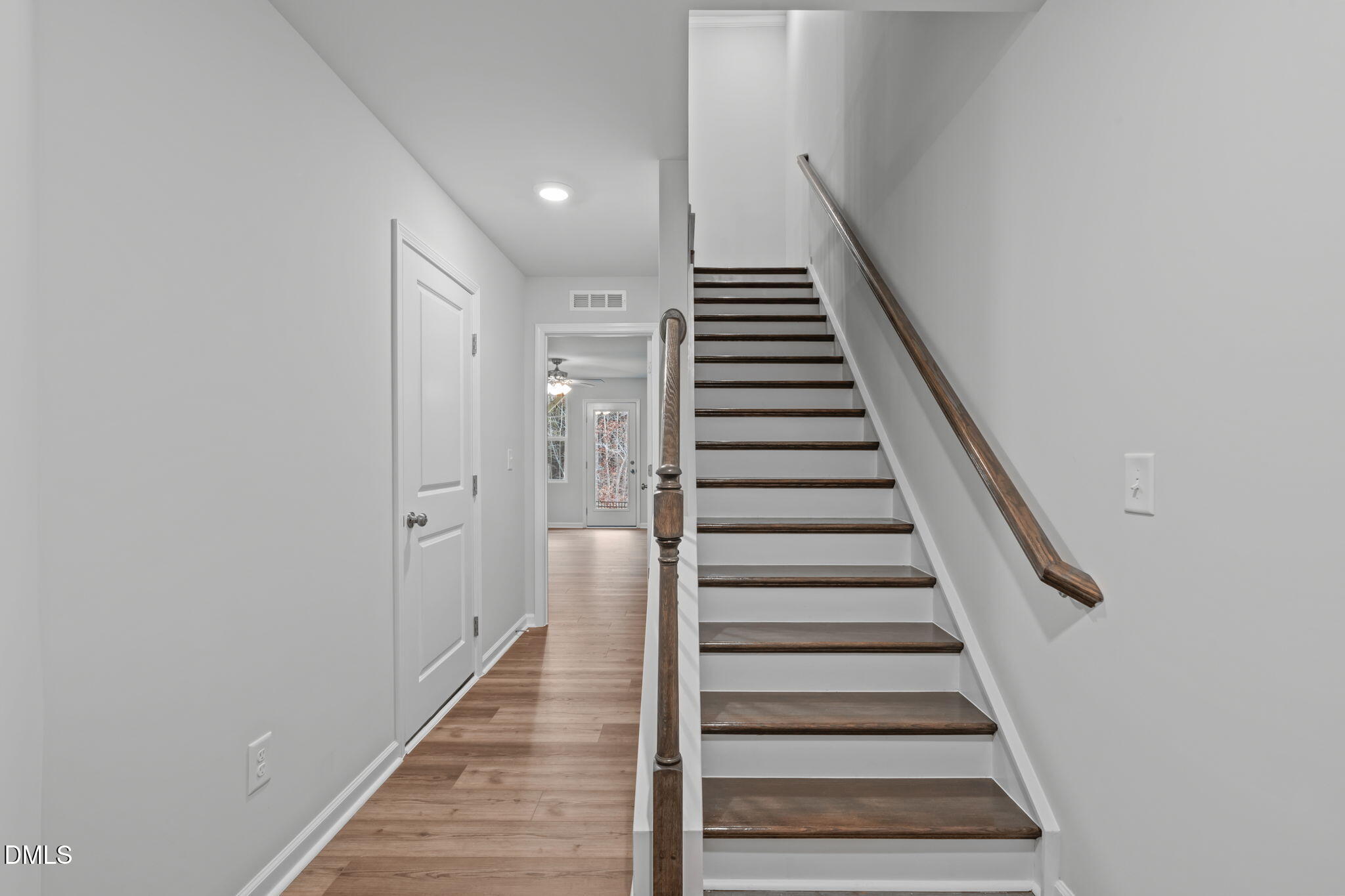 504 Light Oak Way Apex, NC 27539 - Photo 5 of 38 a view of a hallway with wooden floor and entryway