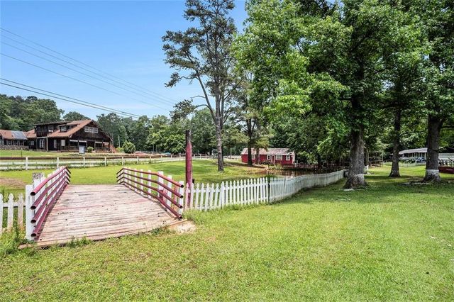 a view of a swimming pool with deck and a garden