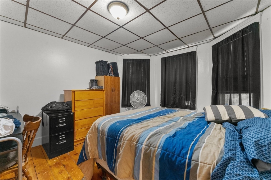 15 Steele Street Worcester, MA 01607 - Photo 17 of 42 a bedroom with a bed and wooden floor