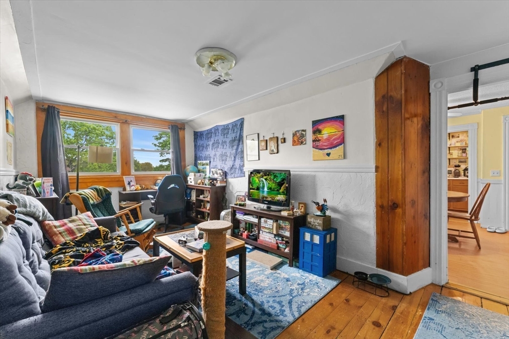 15 Steele Street Worcester, MA 01607 - Photo 25 of 42 a living room with furniture fireplace and a large window