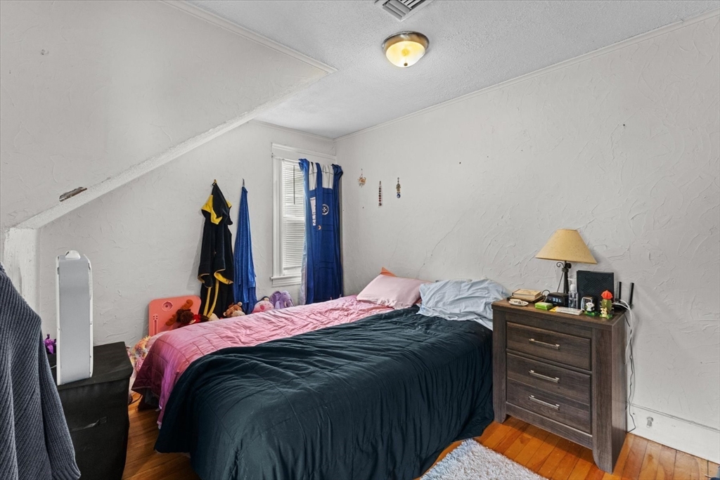 15 Steele Street Worcester, MA 01607 - Photo 28 of 42 a bed room with a bed and a lamp