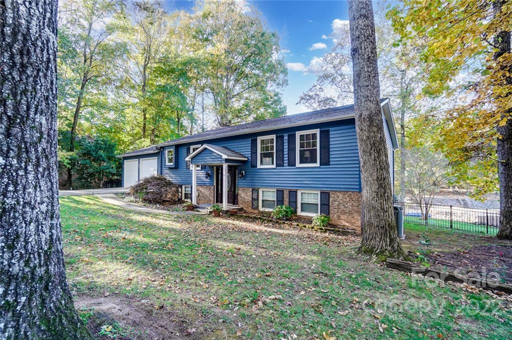 4470 Lake Shore Road North Denver, NC 28037 - Photo 5 of 41 a view of a yard in front of a house with large windows
