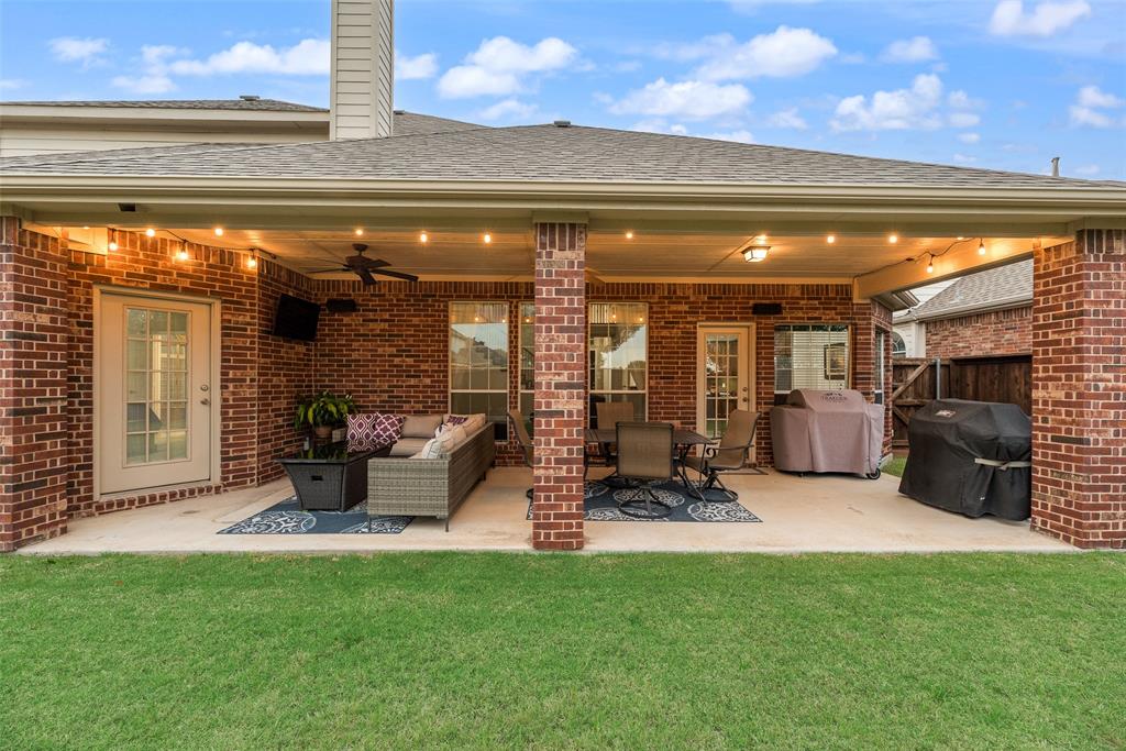 11920 Vienna Apple Road Fort Worth, TX 76244 - Photo 39 of 40 Expansive backyard patio equipped with lights, speakers, ceiling fans, gas stub and 220V outlet at 11920 Vienna Apple in Villages of Woodland Springs community in North Fort Worth