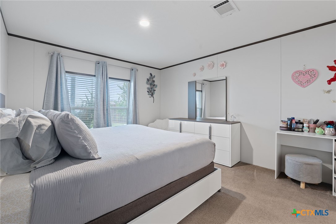121 Fate Court Kyle, TX 78640 - Photo 11 of 23 a bedroom with a bed and a window