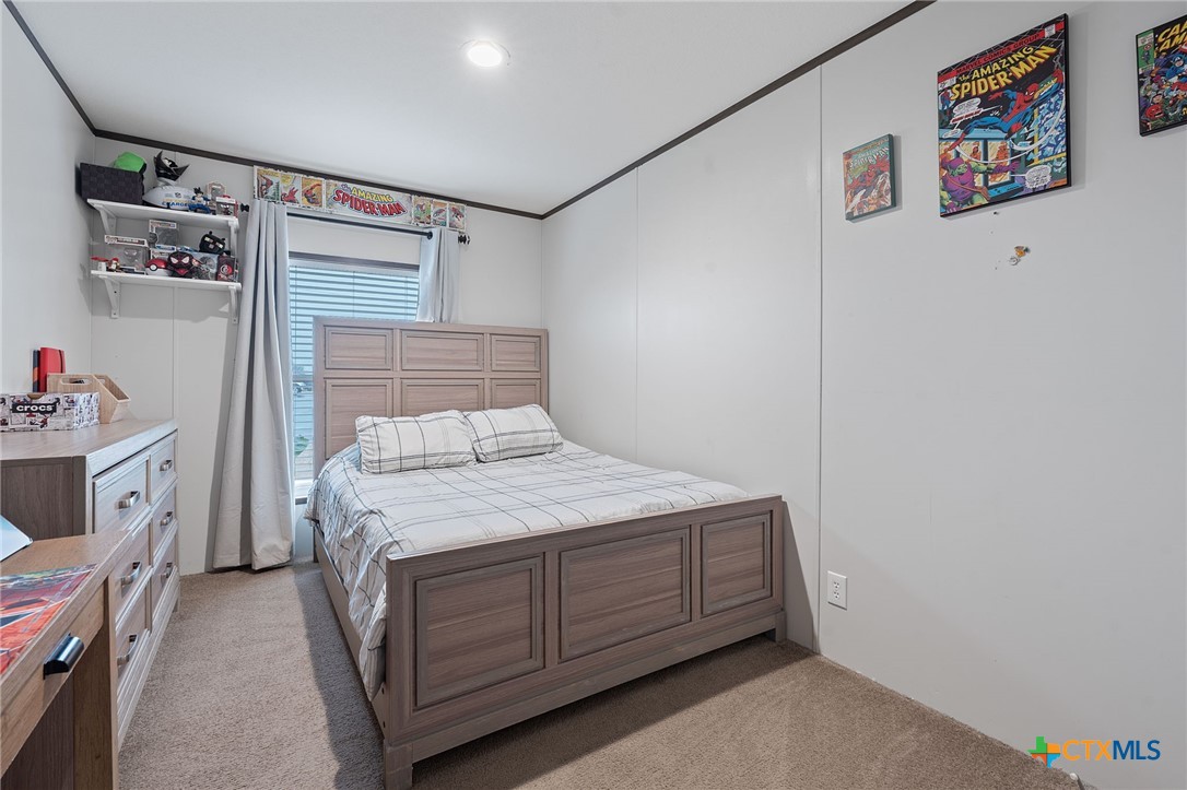 121 Fate Court Kyle, TX 78640 - Photo 17 of 23 a bedroom with a bed and a window